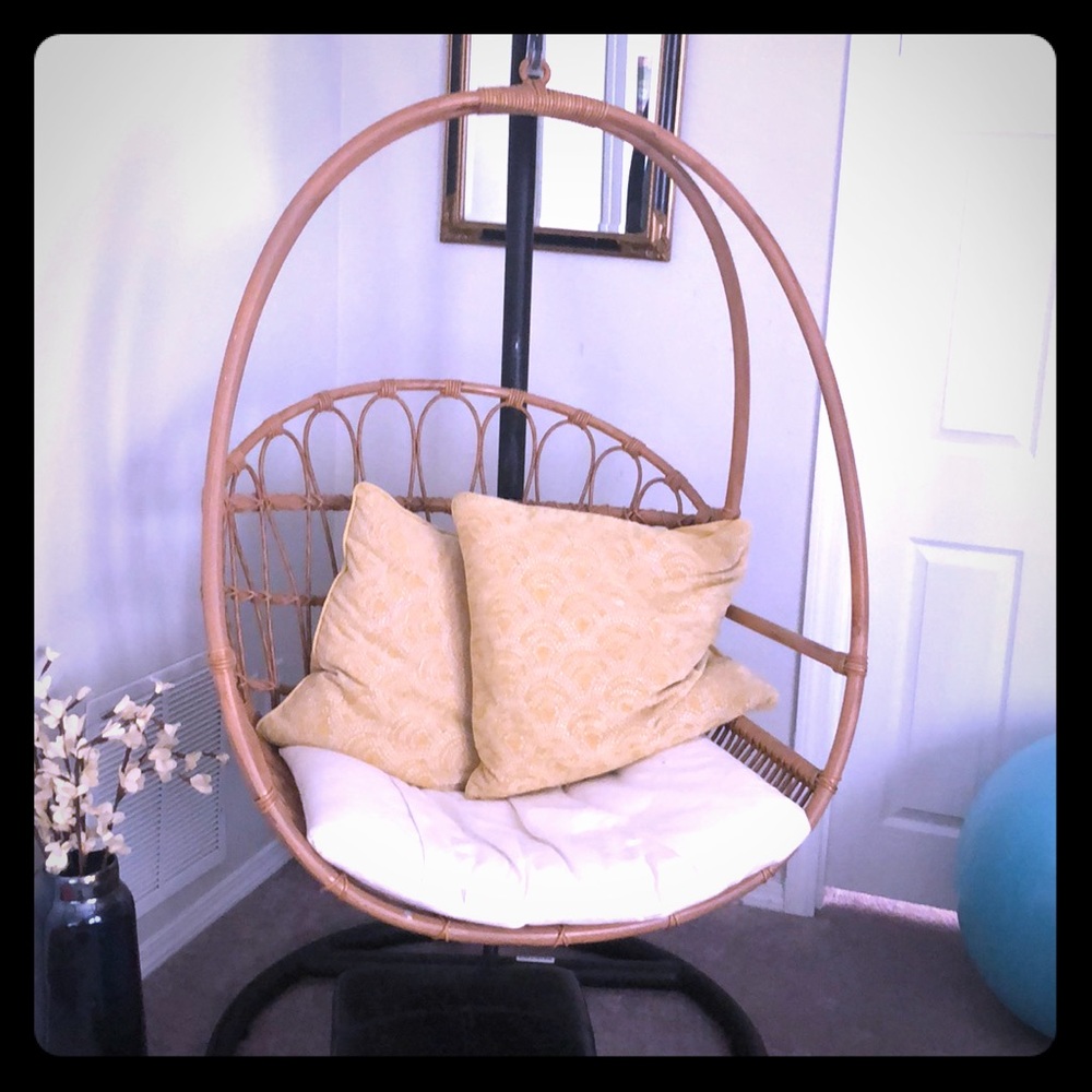 Pier One tan wooden swing with black metal stand.
